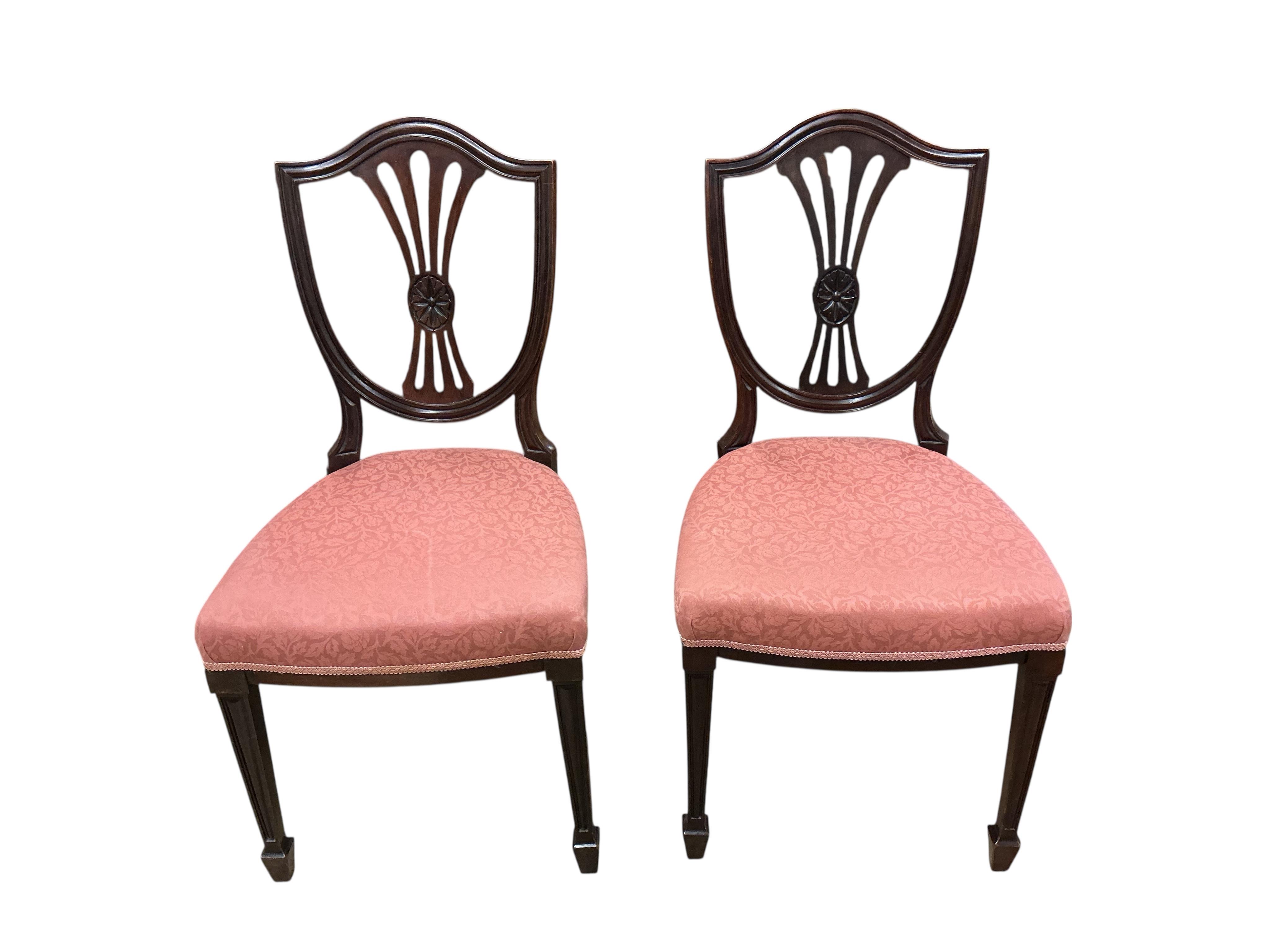 A set of fourteen early 20th century mahogany Sheraton style mahogany dining chairs, two with arms
